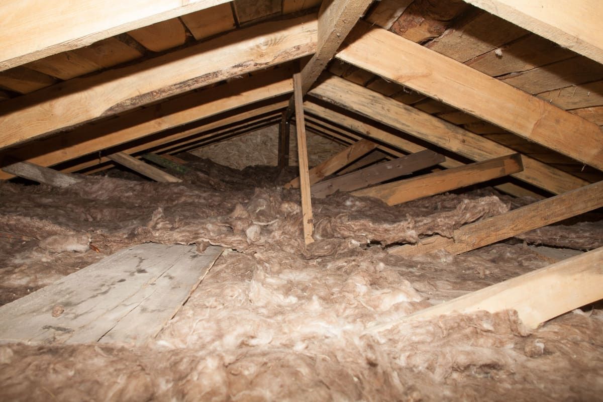 Attic floor with loose insulation between the ceiling joists