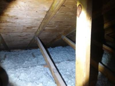 Blown-in insulation packed against the underside of the roof deck where the soffit vents enter the attic